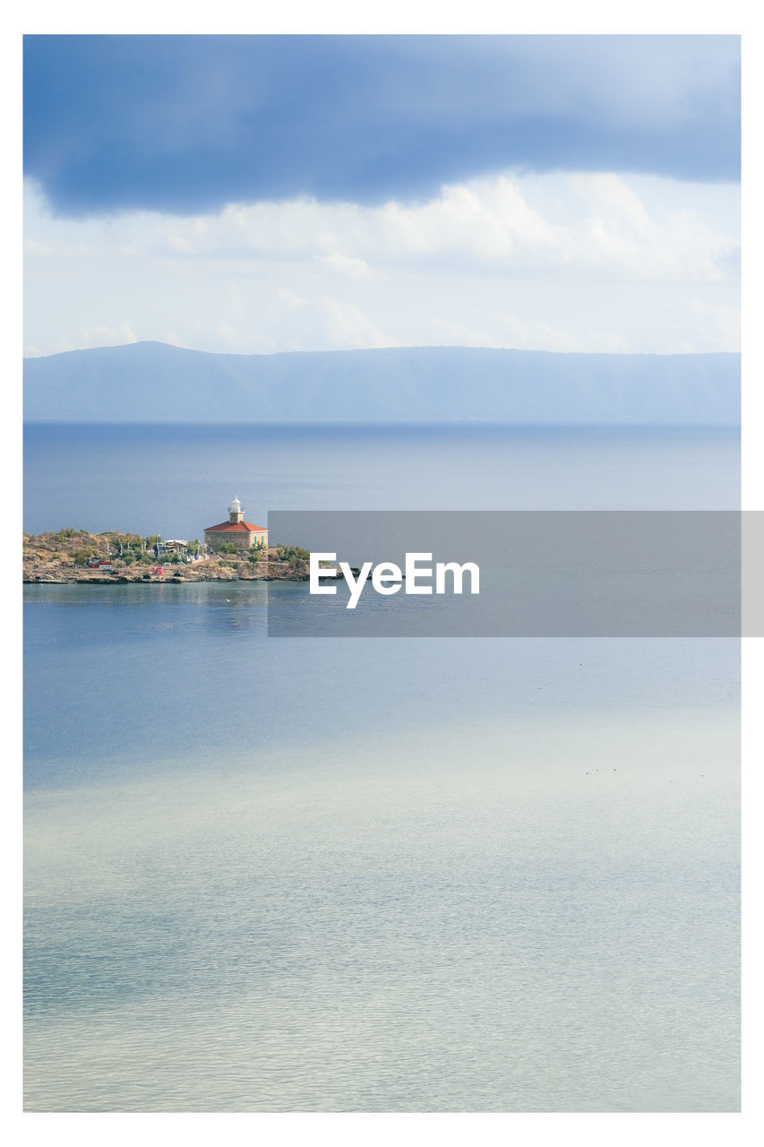 SCENIC VIEW OF SEA AGAINST BUILDINGS