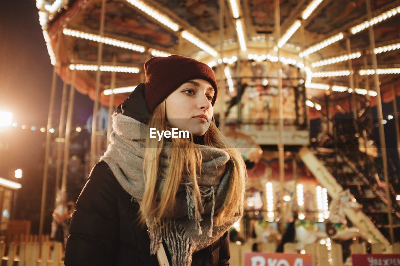 Woman looking at amusement park during winter