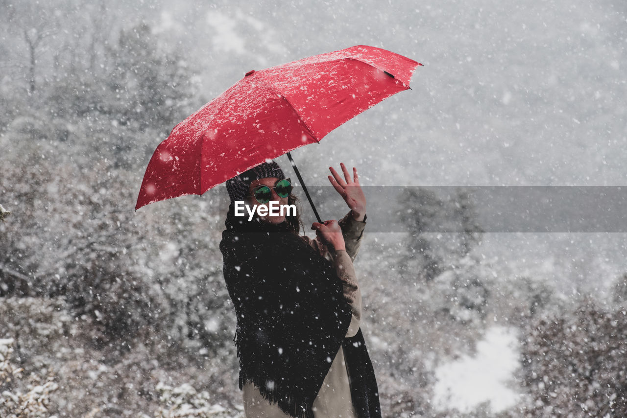 WOMAN STANDING ON WET DURING WINTER