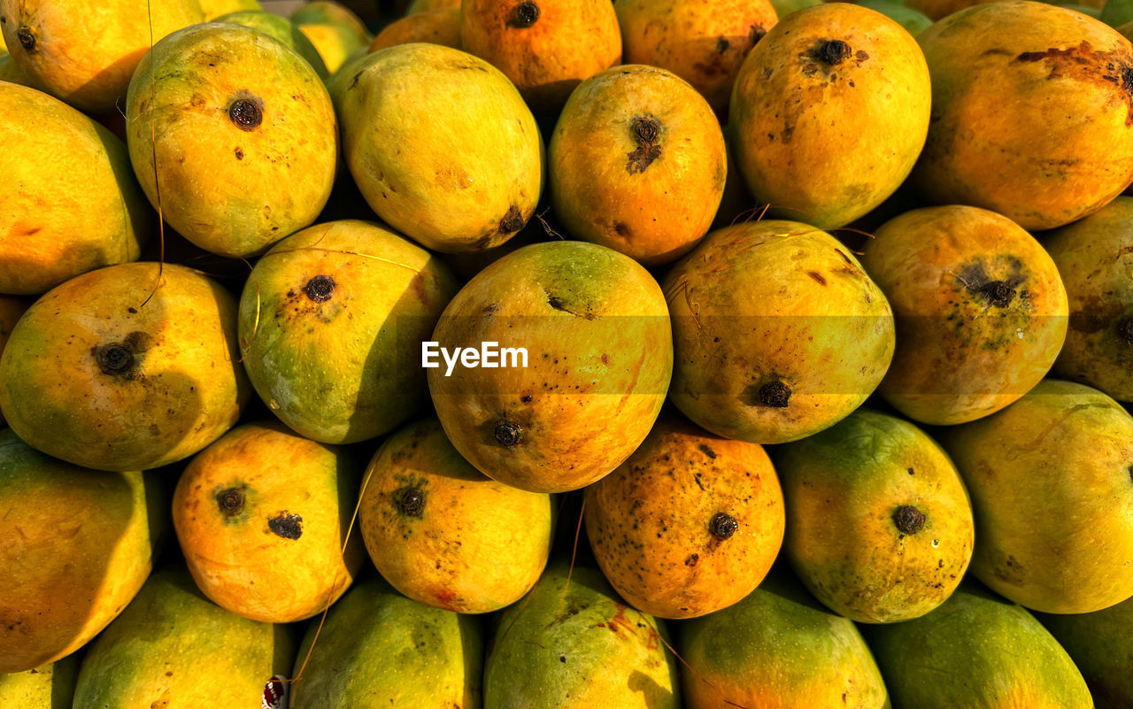 food and drink, food, healthy eating, fruit, wellbeing, plant, freshness, large group of objects, produce, abundance, backgrounds, full frame, no people, market, yellow, for sale, market stall, close-up, citrus fruit, still life, retail, tropical fruit, high angle view, orange color, ripe