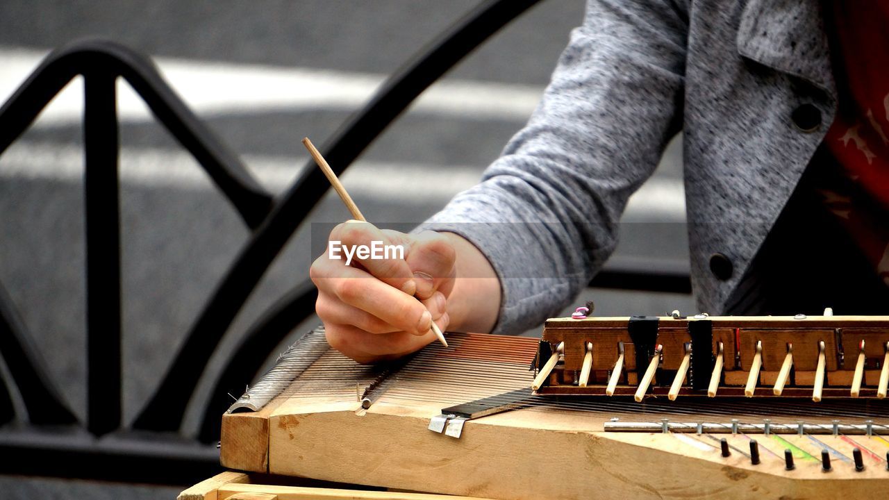 Cropped image of man playing traditional music