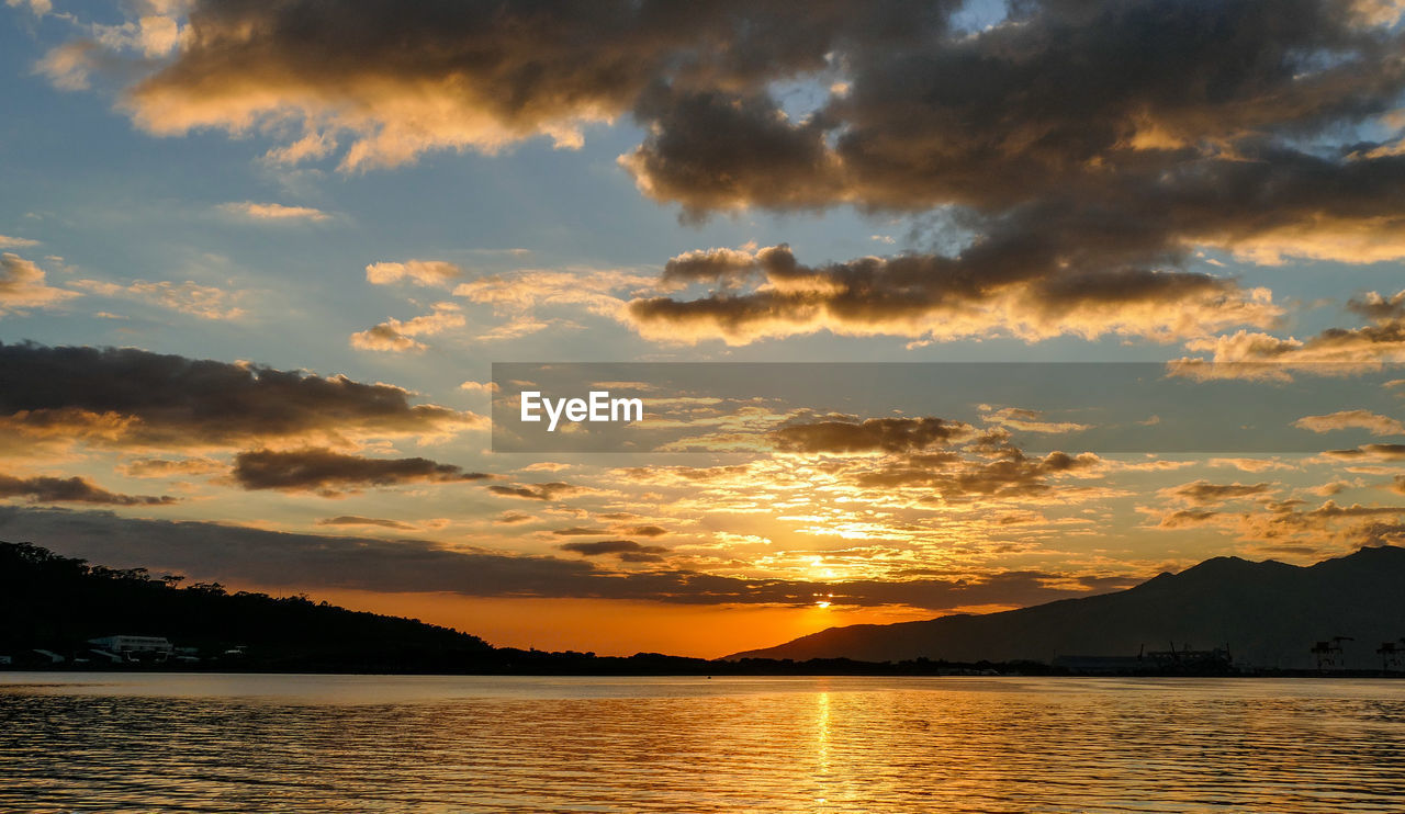 Scenic view of lake against sky during sunset