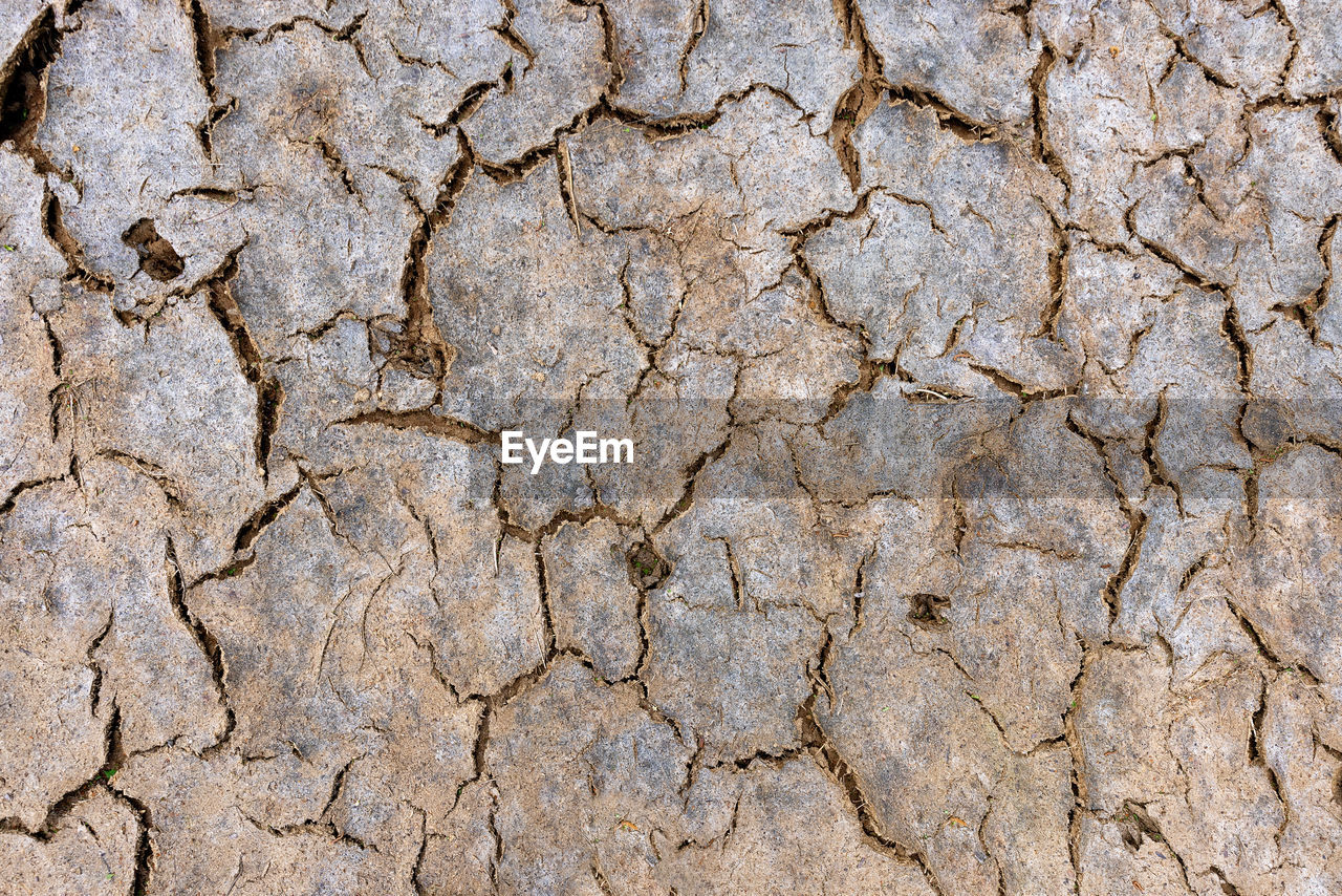 cracked, backgrounds, full frame, climate, drought, dry, arid climate, textured, soil, no people, environment, pattern, nature, land, scenics - nature, barren, day, extreme terrain, rough, dirt, landscape, field, close-up, environmental issues, outdoors, desert, stone wall, mud, brown, high angle view, wall, flooring, geology, bad condition