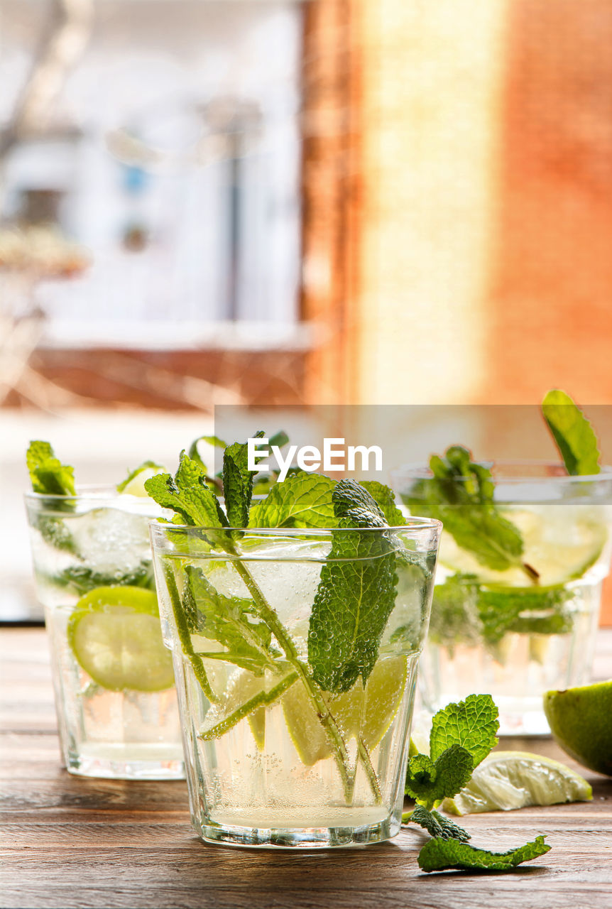 Close-up of drinks served on wooden table