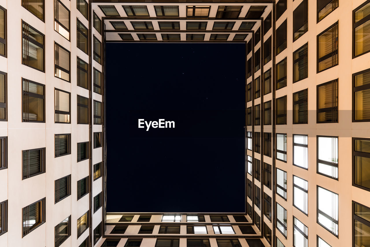 DIRECTLY BELOW SHOT OF MODERN BUILDING AGAINST SKY