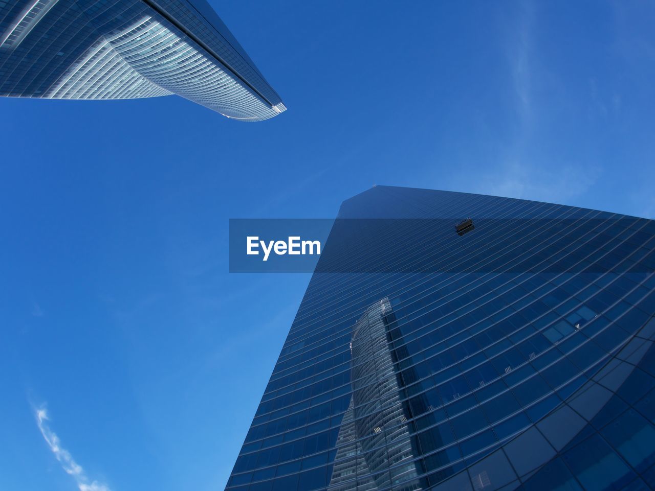 blue, sky, architecture, built structure, building exterior, office building exterior, skyscraper, city, building, low angle view, business, office, glass, nature, no people, reflection, clear sky, finance, day, sunlight, outdoors, line, futuristic, cloud, corporate business, light, tower