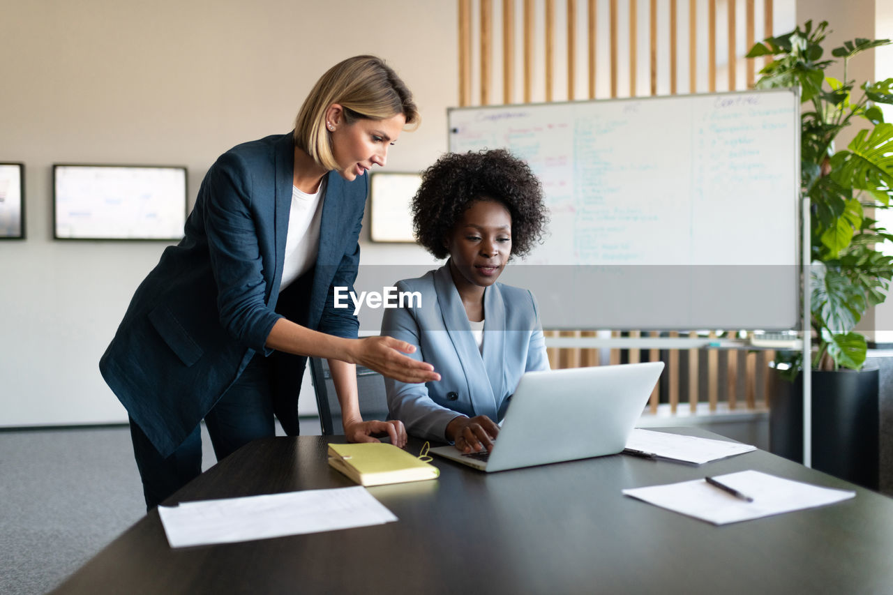 Diverse businesswomen using netbook together