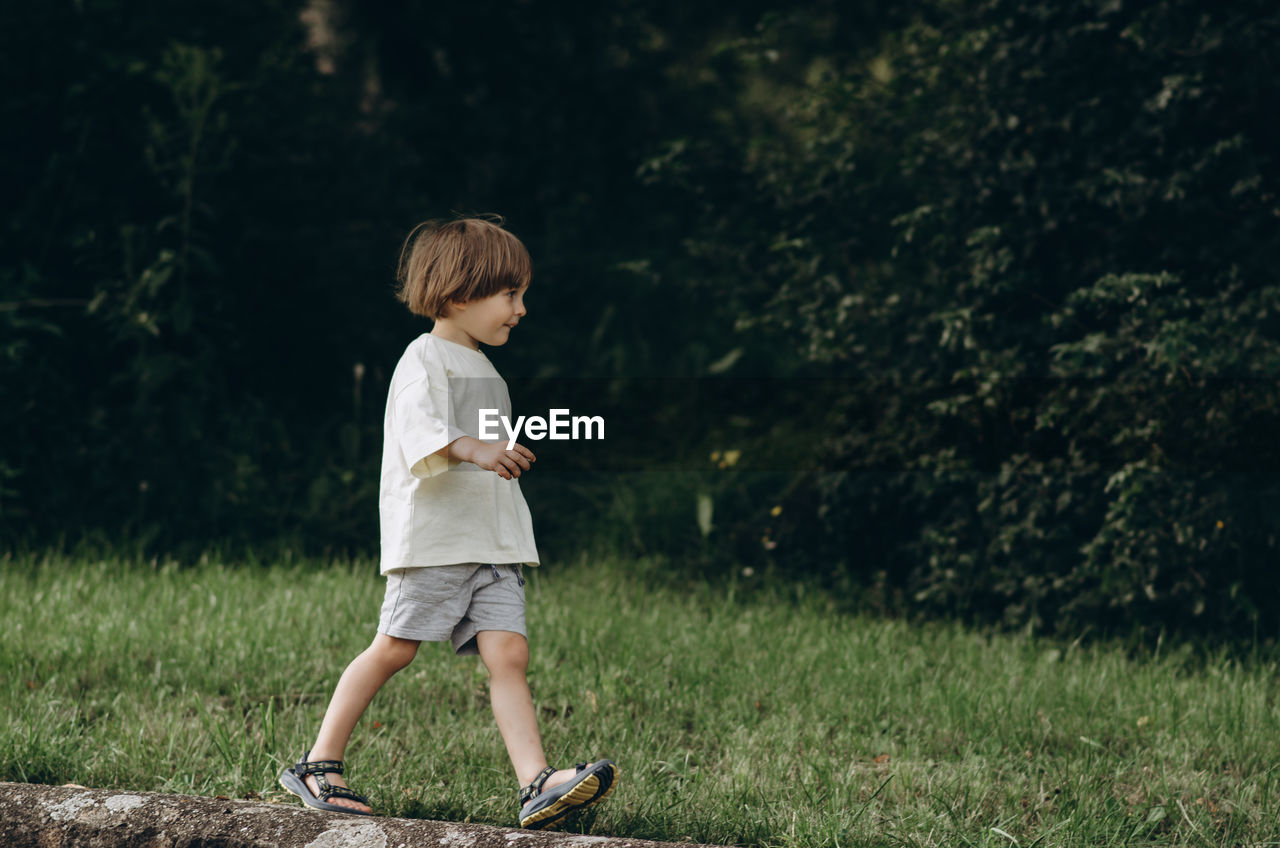 Full length of boy standing on field