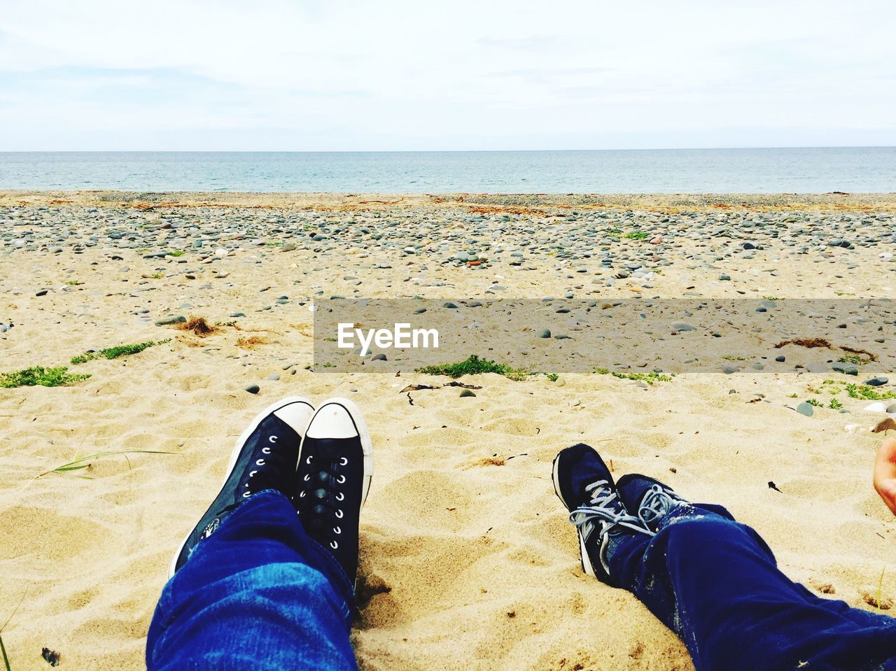 LOW SECTION OF PERSON STANDING ON BEACH