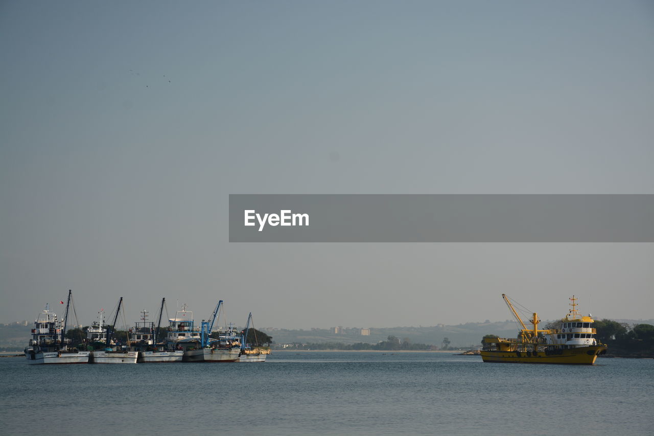 Ships in water against sky