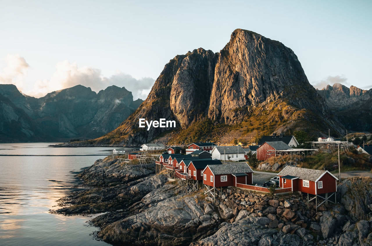 Iconic lofoten - red houses in hamnøy, mountains backdrop.