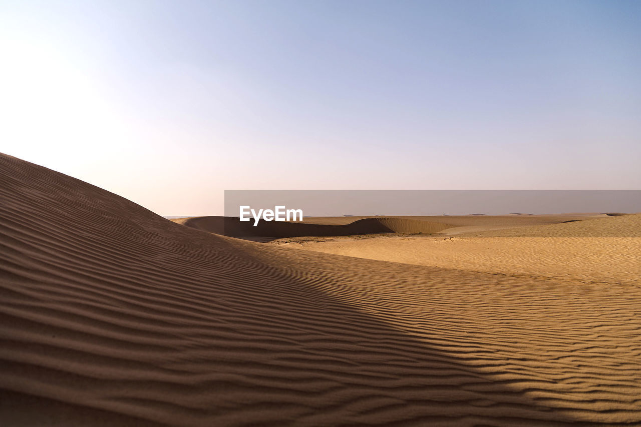 Scenic view of desert against clear sky