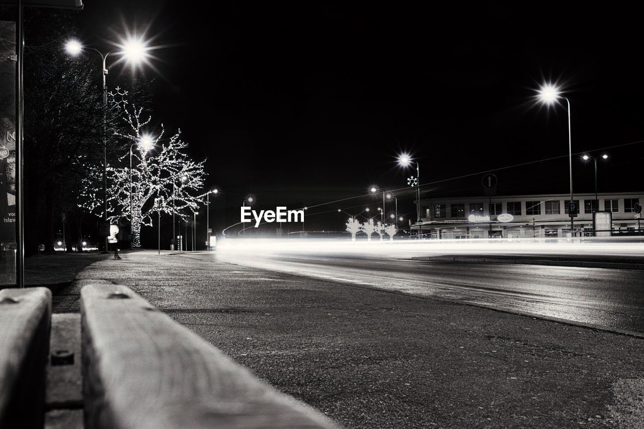 Illuminated light trails on road at night