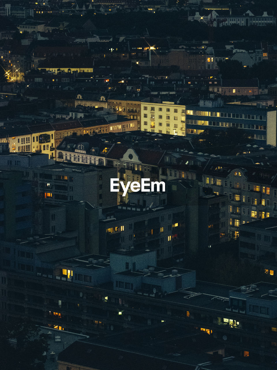 High angle view of illuminated city street and buildings at night