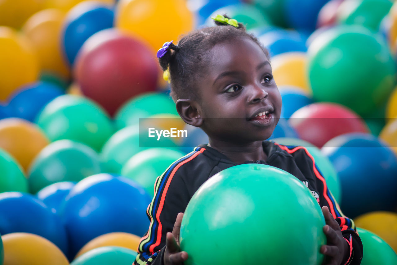 Close-up of cute girl playing with balls
