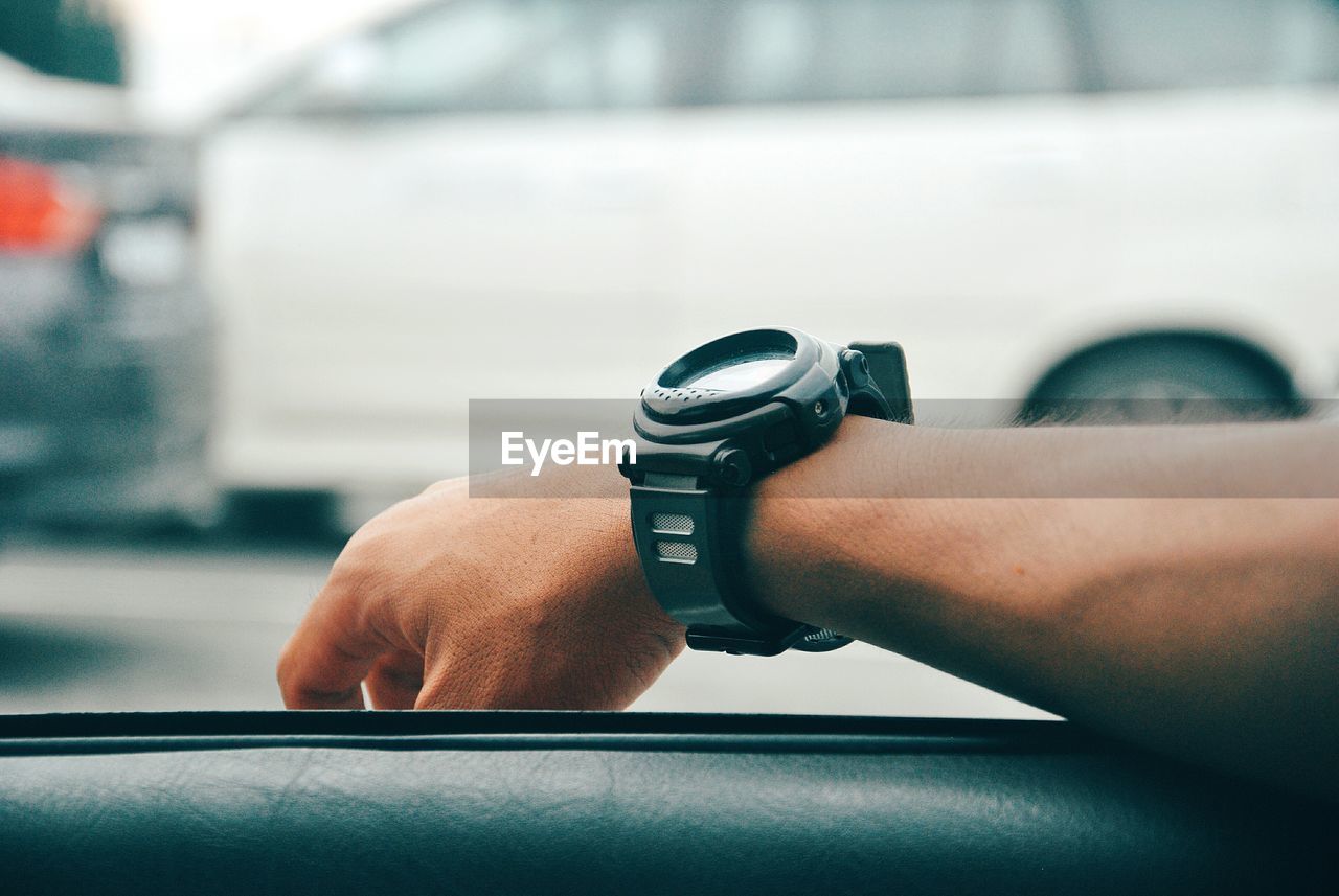 CLOSE-UP OF HAND HOLDING CAMERA