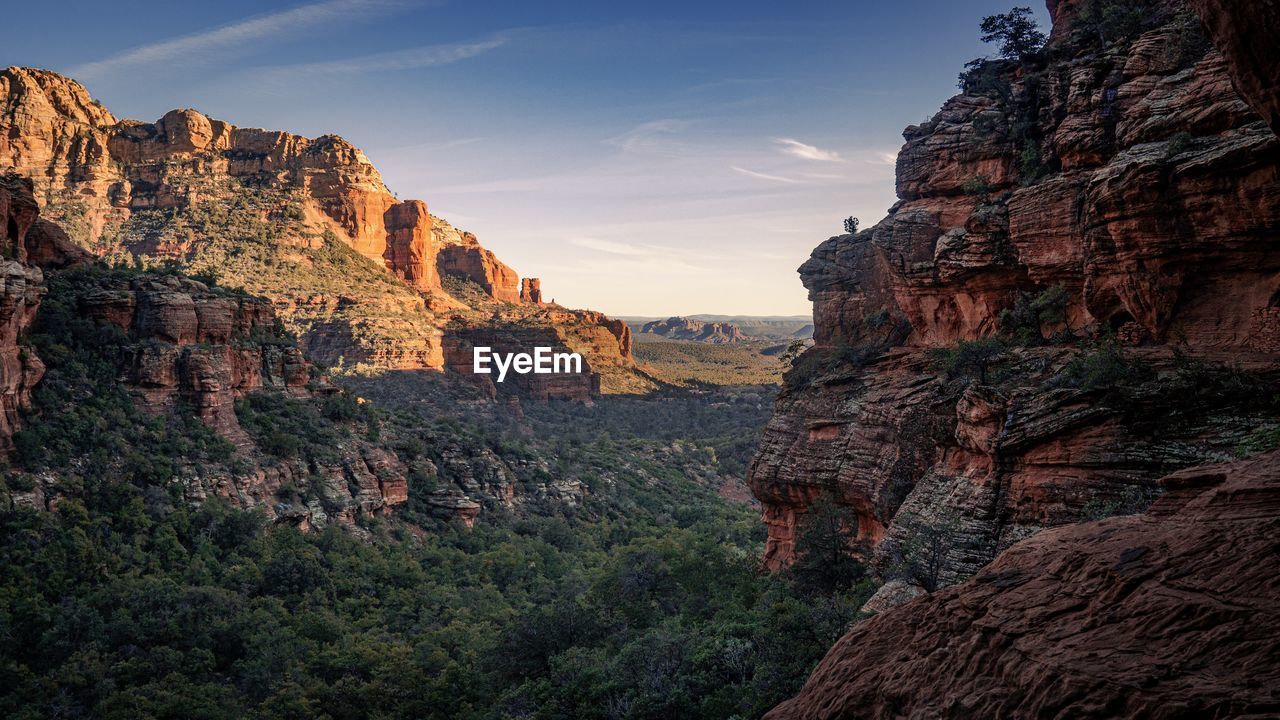 Rock formations on landscape against sky