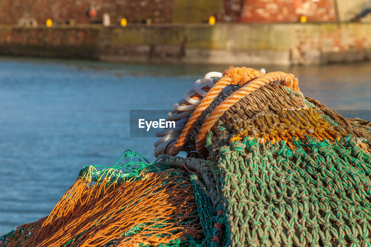 Fishing net at harbor during sunny day