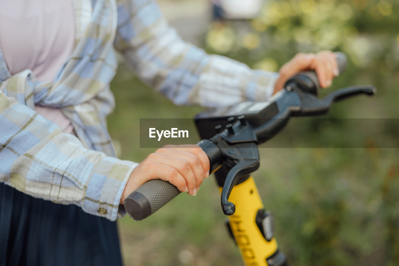 midsection of man holding bicycle