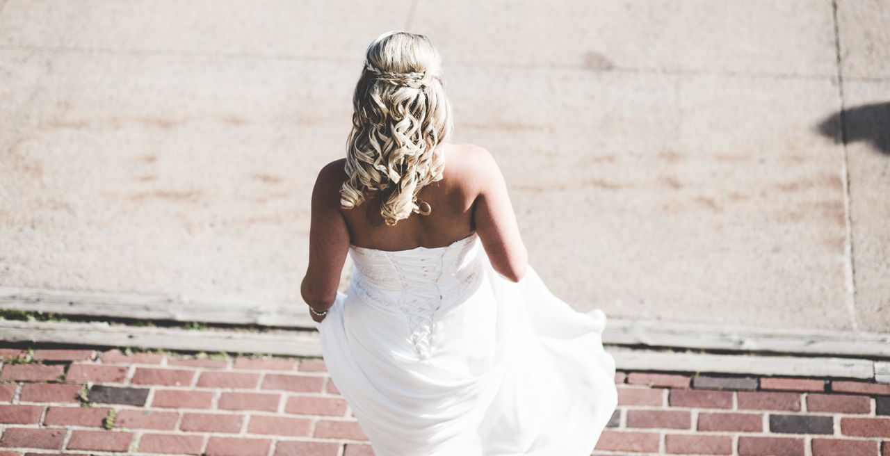 YOUNG WOMAN LOOKING AWAY WHILE STANDING ON WHITE SURFACE