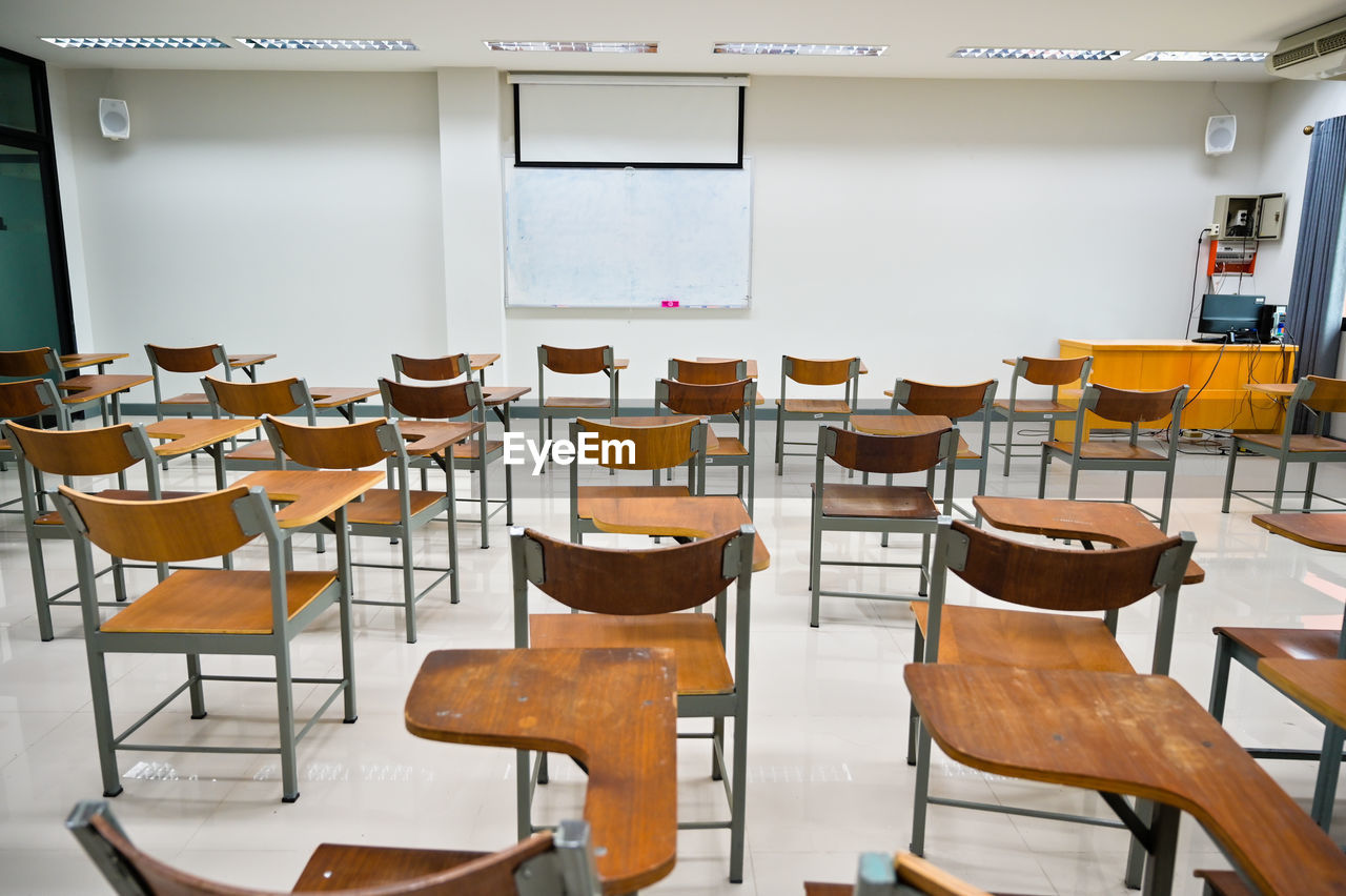 Empty chairs and tables in classroom