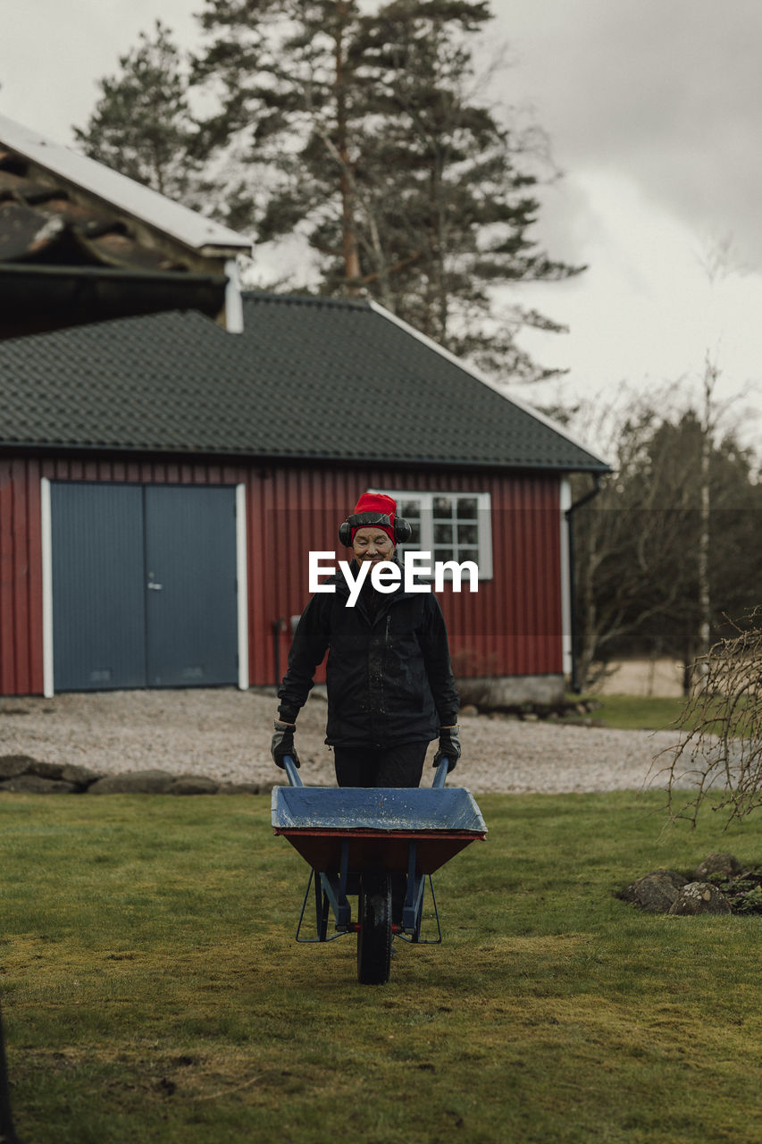 Woman pushing wheelbarrow