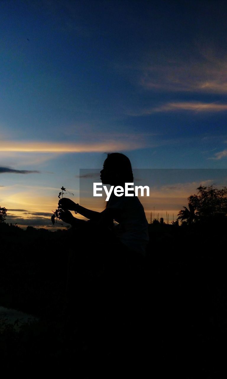 SILHOUETTE OF MAN AT DUSK