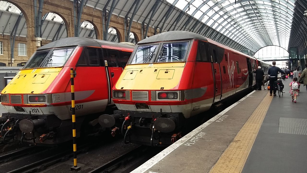 TRAIN ON RAILROAD STATION PLATFORM