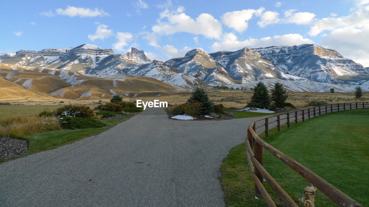 Empty road along countryside landscape