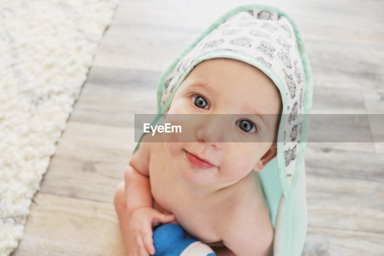 A small baby  boy happily looking at the camera after a bath. 