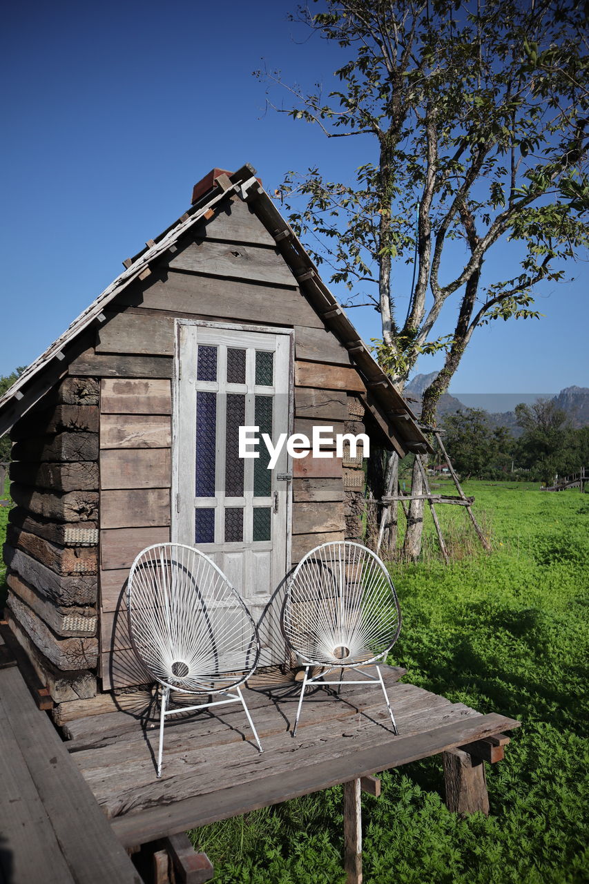 Built structure on field by building against sky