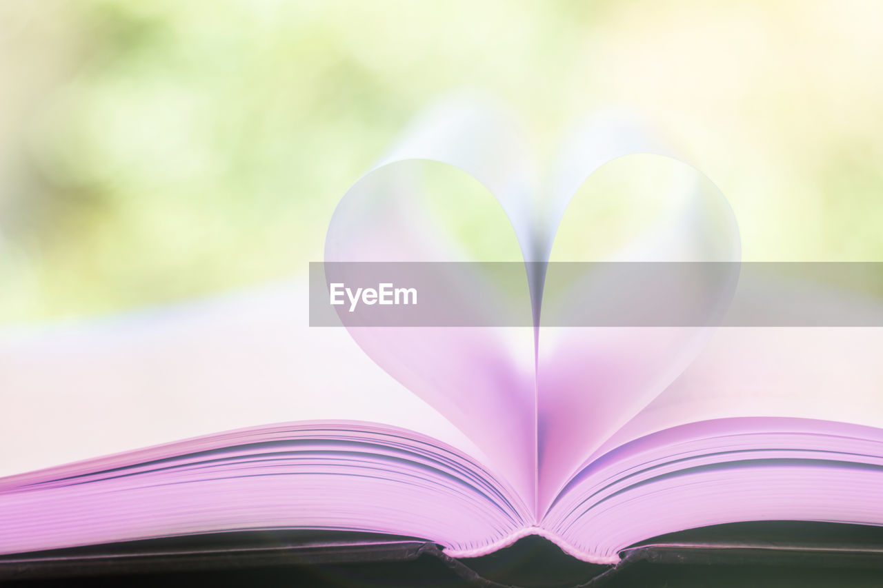 Close-up of heart shape on book at table