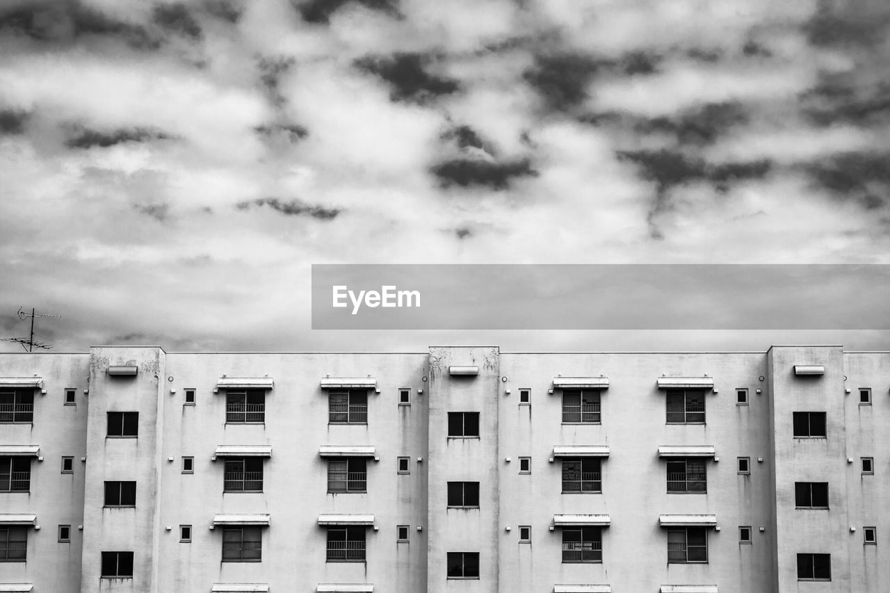 Residential building against cloudy sky