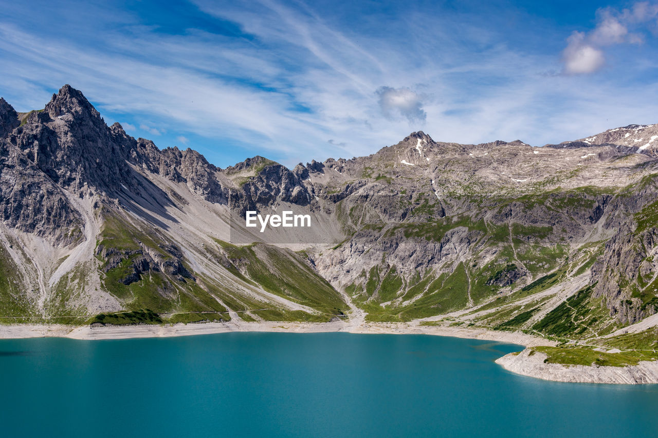 Scenic view of lake and mountains against sky