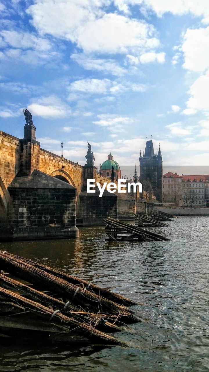 View of river by buildings against sky