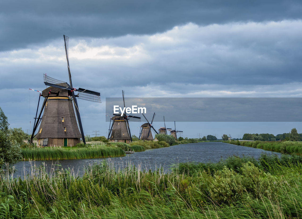 WINDMILL ON FIELD AGAINST SKY