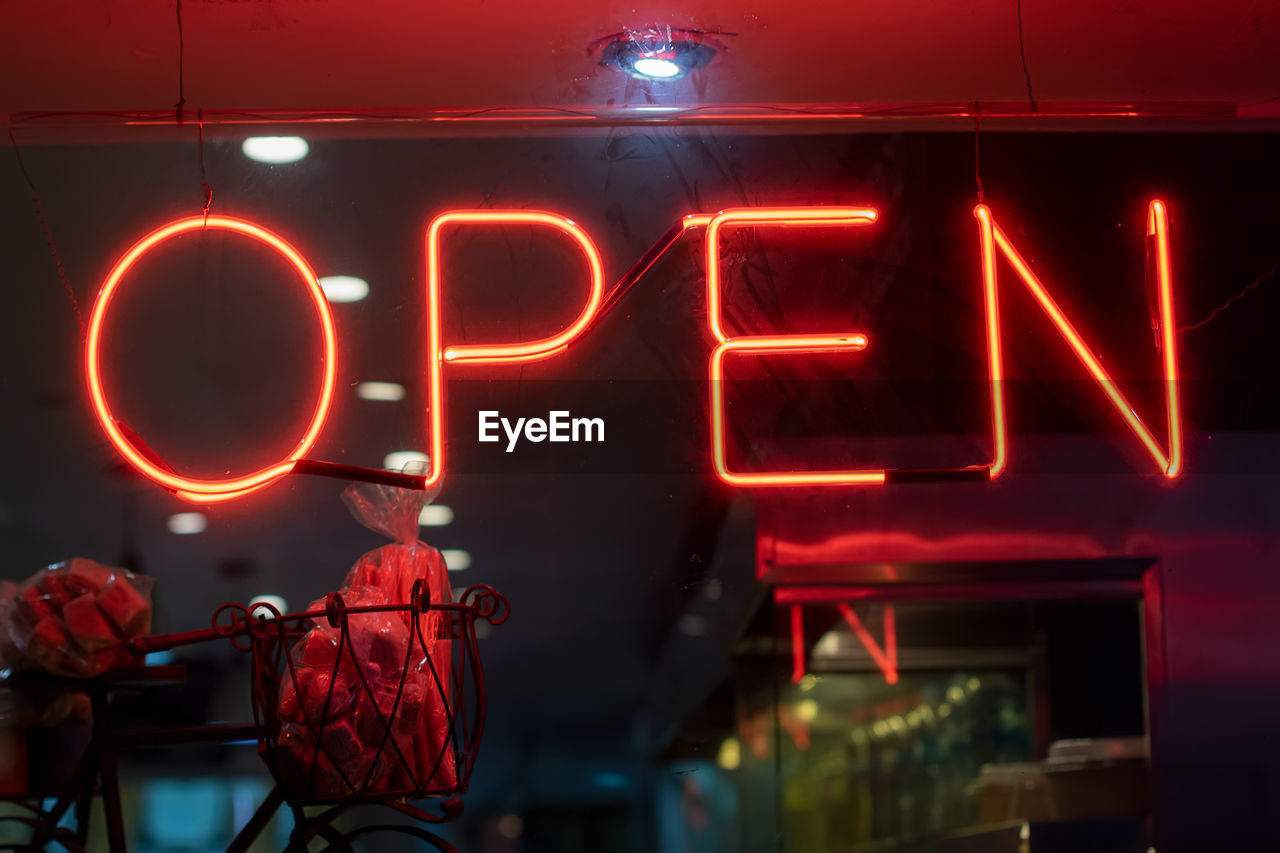 Illuminated open sign at night