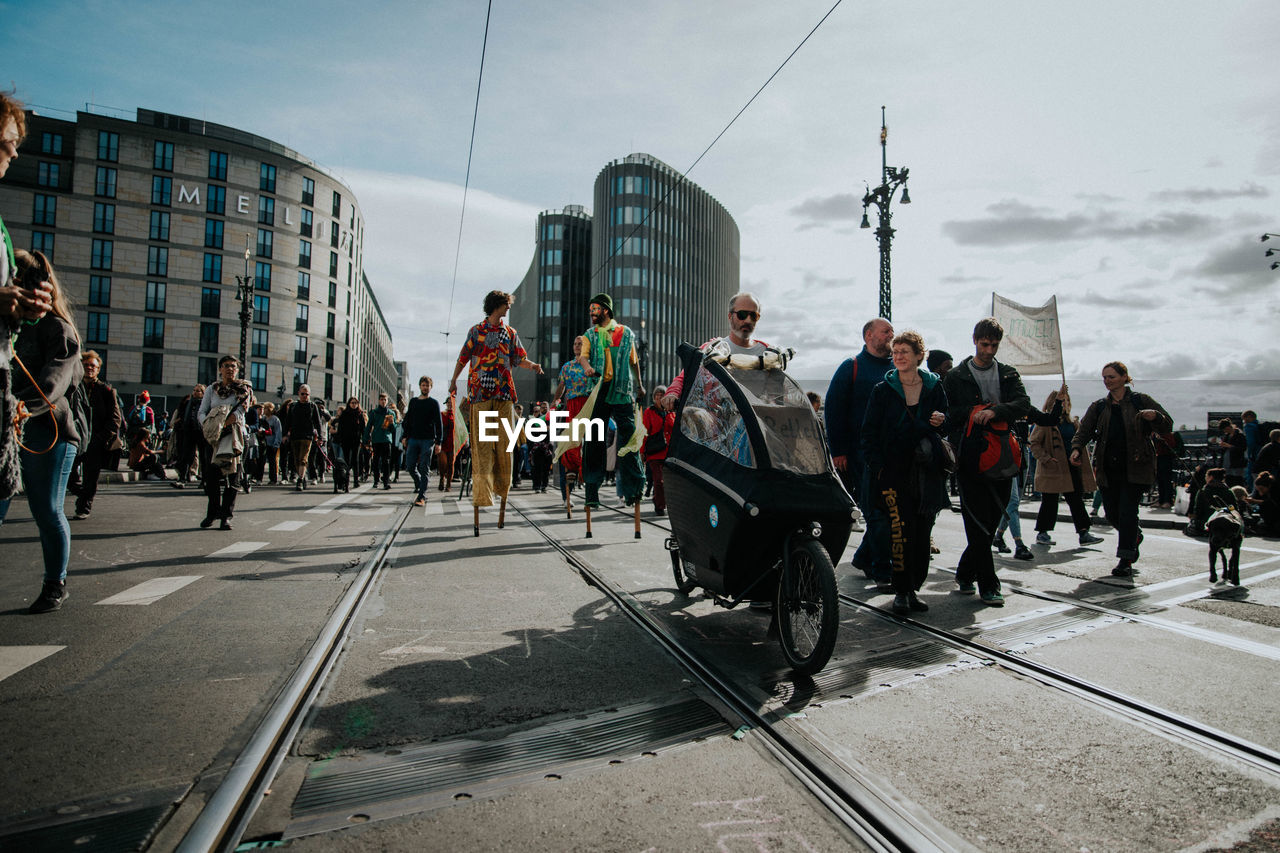 PEOPLE WALKING ON RAILROAD TRACK