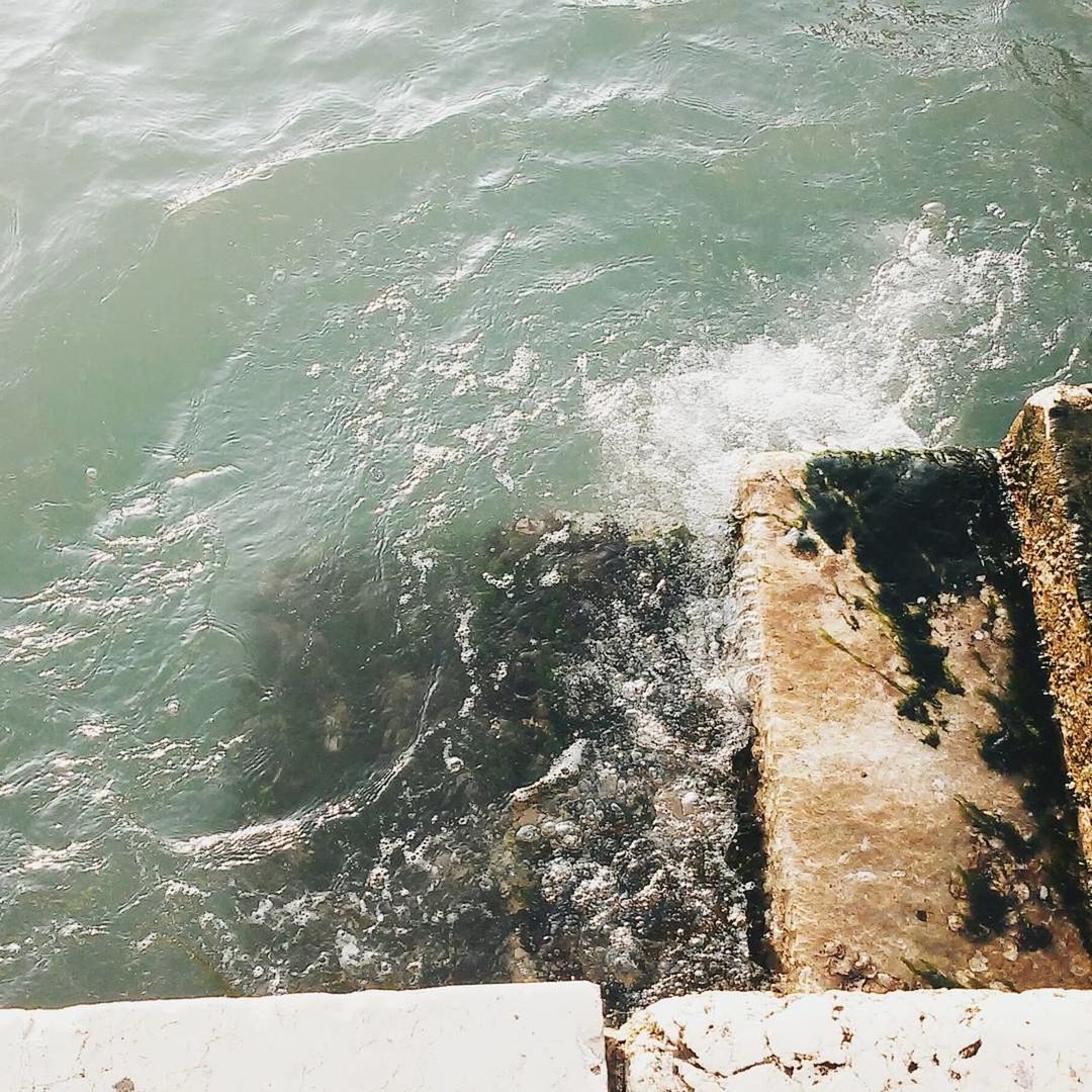 CLOSE-UP OF SEA WAVES SPLASHING ON SHORE