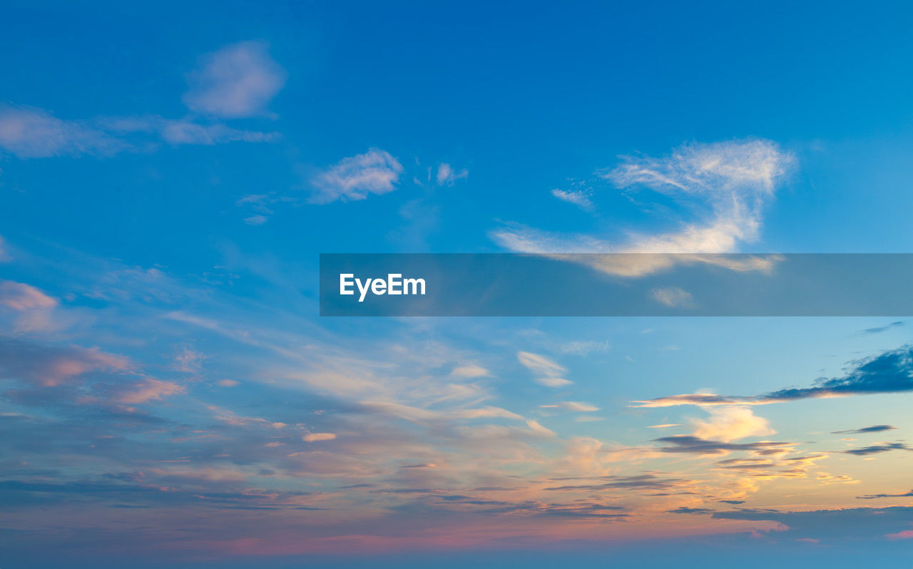 sky, cloud, horizon, blue, beauty in nature, scenics - nature, nature, environment, sunset, tranquility, tranquil scene, afterglow, no people, dusk, cloudscape, dramatic sky, idyllic, landscape, outdoors, sunlight, sea, backgrounds, water, copy space, vibrant color, summer, multi colored, urban skyline, travel, atmosphere, horizon over water, evening, sun, ocean, light - natural phenomenon