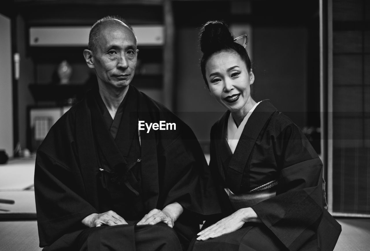Portrait of smiling couple sitting at home