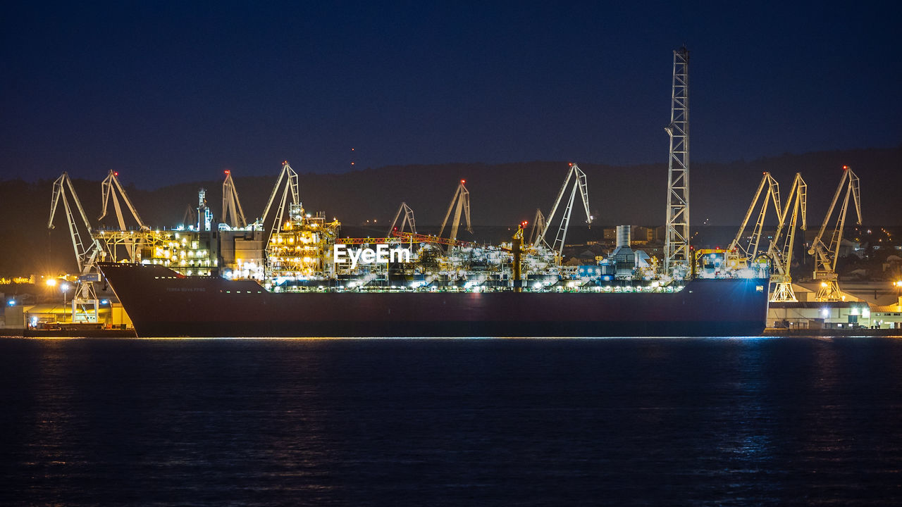 Boats in harbor at night