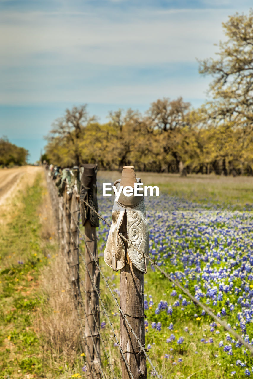 Cowboy boots on a fence, texas hill country