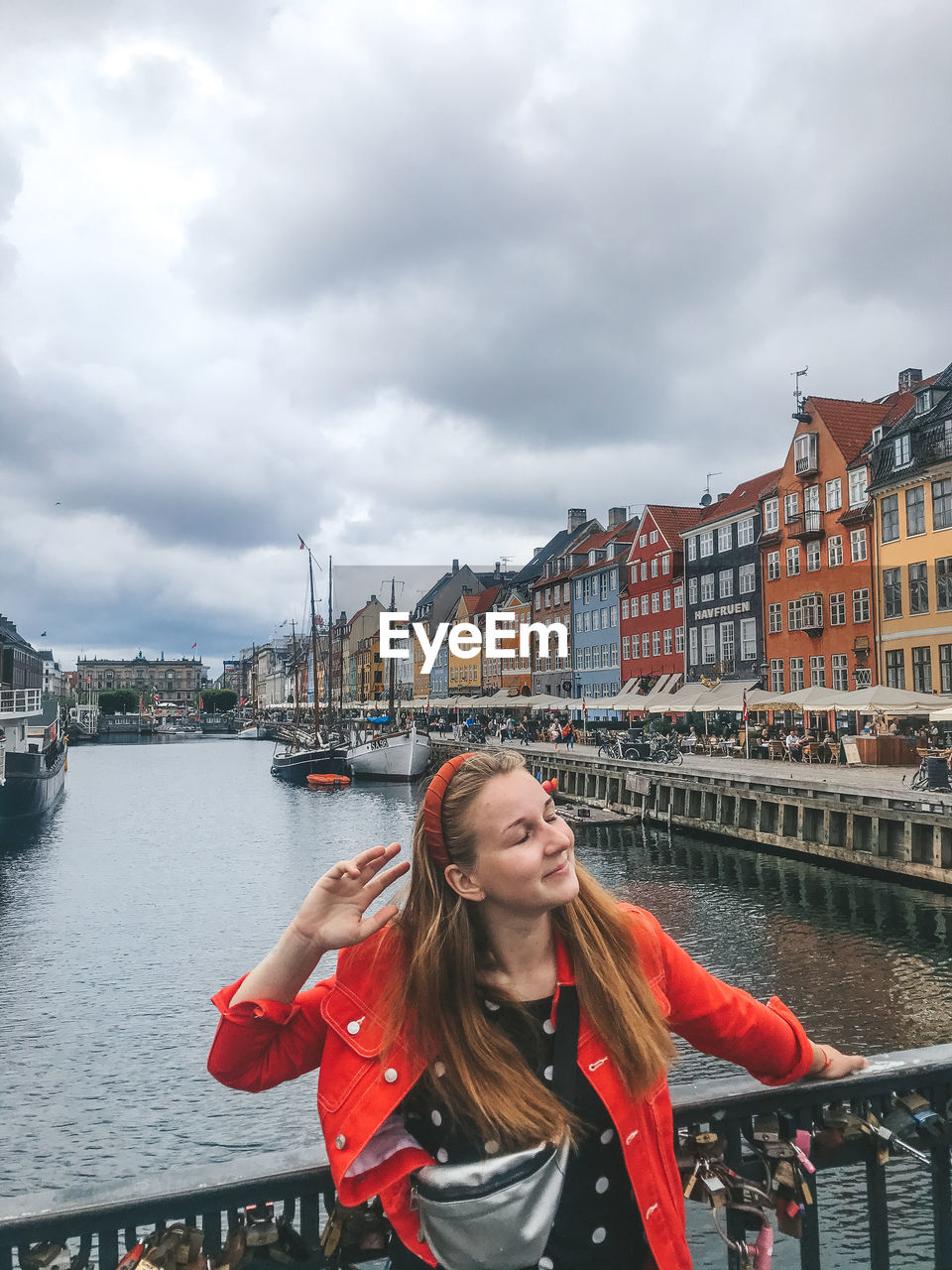 Woman standing on bridge in city