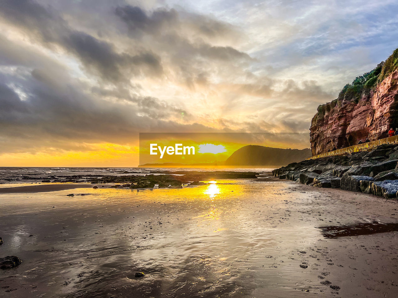 sky, water, sea, sunset, land, beach, cloud, beauty in nature, scenics - nature, coast, nature, shore, environment, ocean, travel destinations, landscape, sun, dramatic sky, tranquility, wave, reflection, body of water, travel, seascape, tranquil scene, sand, coastline, horizon, sunlight, outdoors, no people, dawn, rock, holiday, mountain, trip, vacation, tourism, wind wave, idyllic, orange color, summer, bay, tide, horizon over water, evening, low tide, motion
