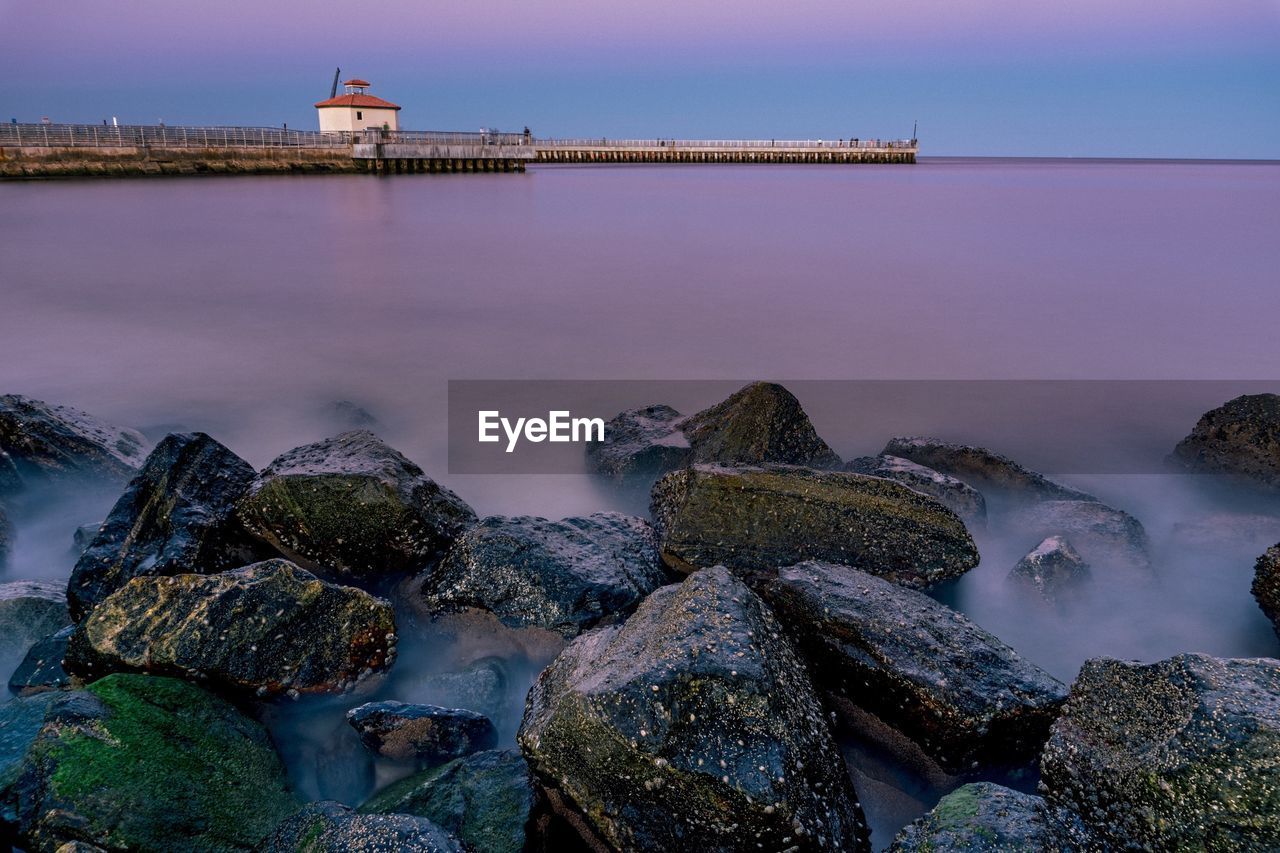 Scenic view of sea against sky at dusk