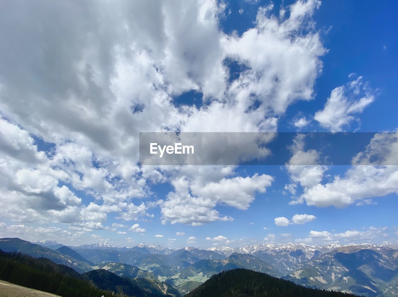 LOW ANGLE VIEW OF CLOUDS OVER MOUNTAIN