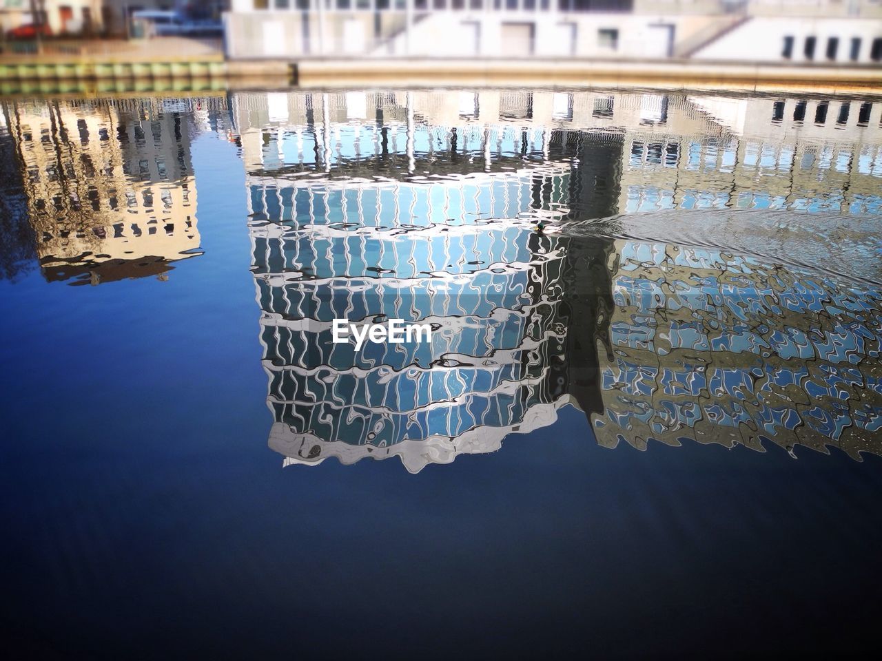 High angle view of building reflection on lake
