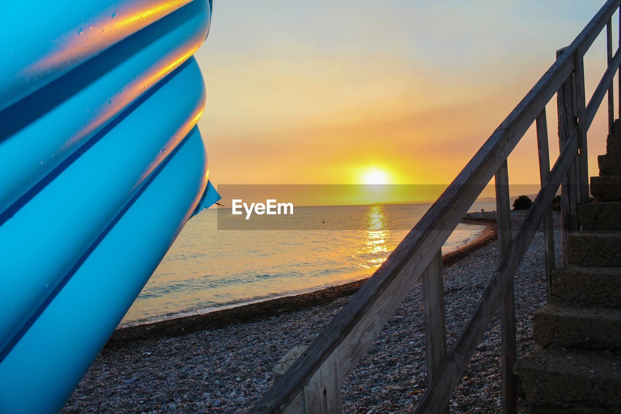 CLOSE-UP OF SEA AGAINST SUNSET SKY