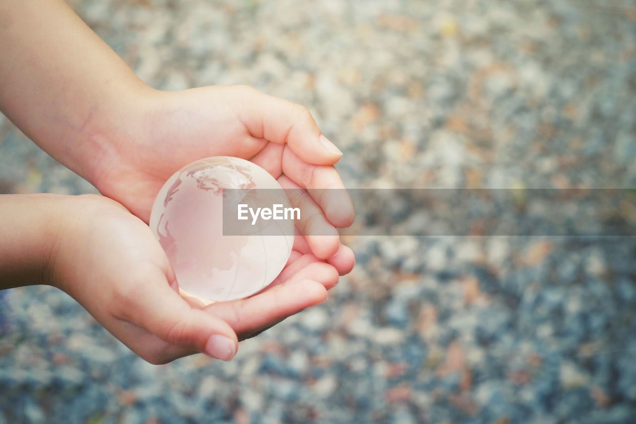 Close-up of person holding crystal ball